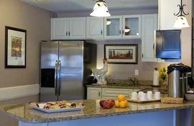 Bright kitchen area with appliances and fruit display