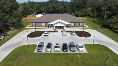 Aerial view of BeeHive Homes Assisted Living exterior and parking area