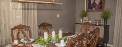 Elegant dining area with wooden chairs and table settings