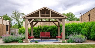 Outdoor seating area with a pergola and shrubs