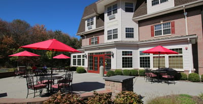Outdoor patio area with umbrellas and seating