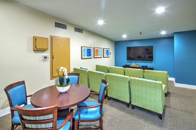 Bright common area with seating and television