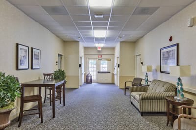 Bright interior hallway with seating and plants
