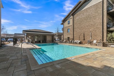Swimming pool area with seating and lounge chairs