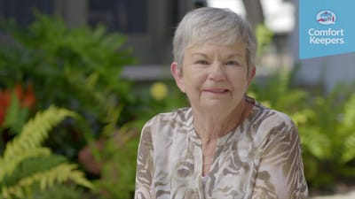 Smiling resident in a garden setting
