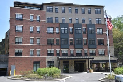 Exterior view of the assisted living facility with flag