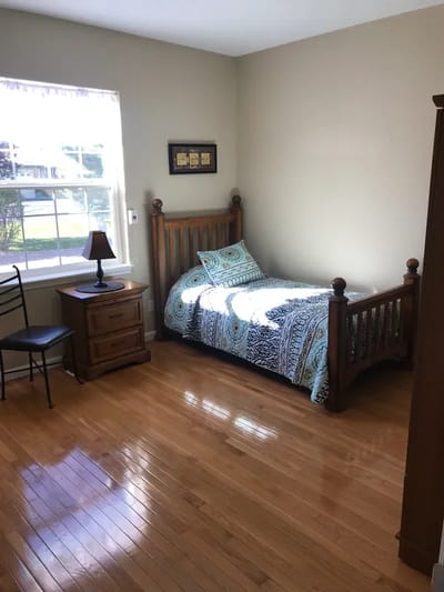 A private resident room with a bed and nightstand