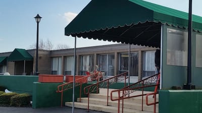 Covered entrance with steps leading to the facility