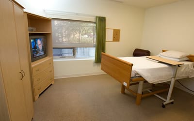 Private resident room with bed and TV
