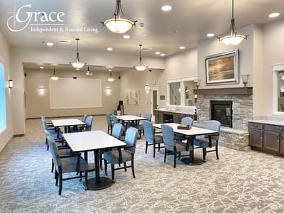 Common area with tables and chairs in a well-lit room