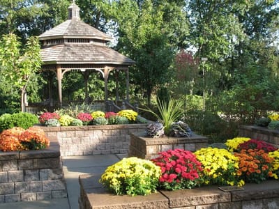 A beautiful garden with colorful flowers and a gazebo