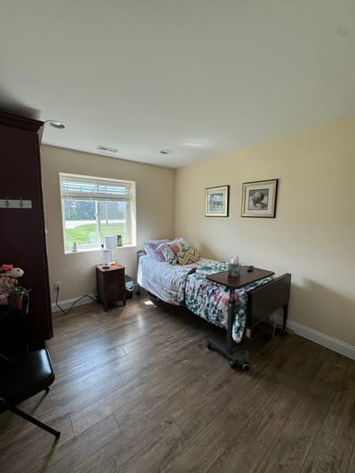 A private resident room with a bed and natural light