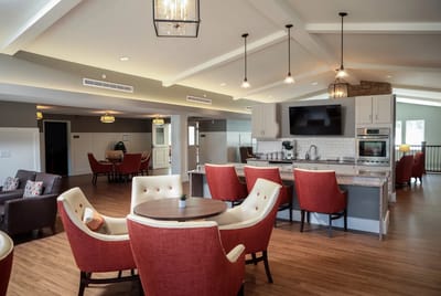 Bright common area with comfortable seating and kitchen