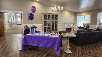 Residents interacting in a common area with refreshments