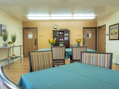 Dining area with tables and floral arrangements