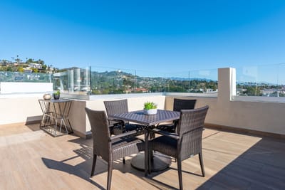 Outdoor dining area with a view of hills