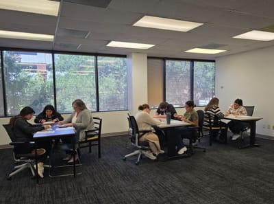 Residents and staff engaged in an activity in a meeting room