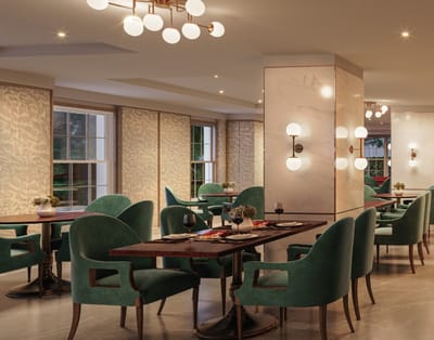 Elegant dining area with green chairs and round tables