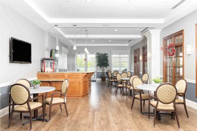 Bright dining area with tables and chairs set up