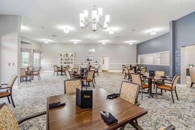 Dining area with tables and chairs set up for meals