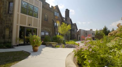 Exterior view of a senior living facility with gardens