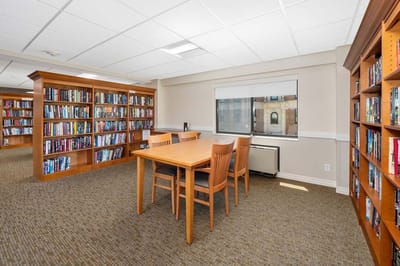 Interior of a library area with bookshelves and a table