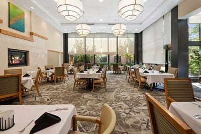 Bright dining room with tables set for meals