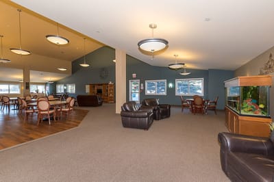 Interior view of the facility's common area with seating and dining tables