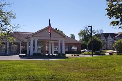 Facility exterior with American flag and gardens
