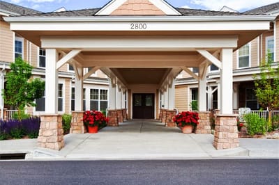 Front entrance of a senior living facility with landscaped approach