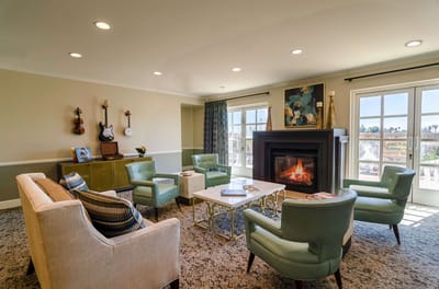 Bright common area with seating and fireplace