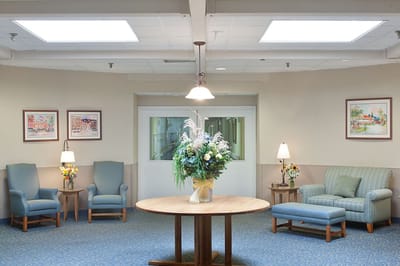 Bright common area with seating and floral arrangement