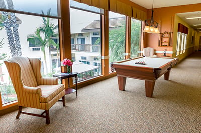 Bright common area with a pool table and seating