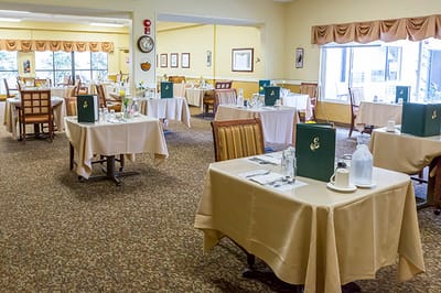 Dining room with neatly set tables and chairs