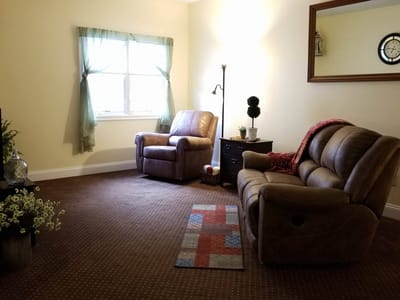Cozy living room with two armchairs and a decorative lamp