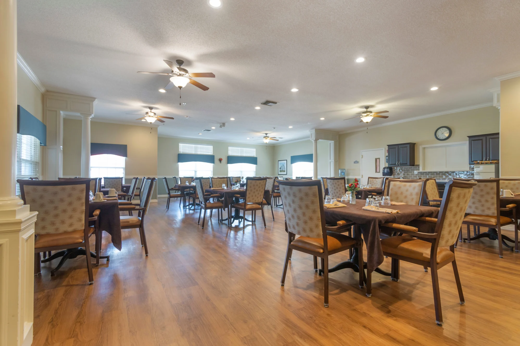 Brightly lit dining room with tables and chairs