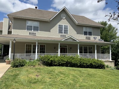 Exterior view of a senior living facility with porch