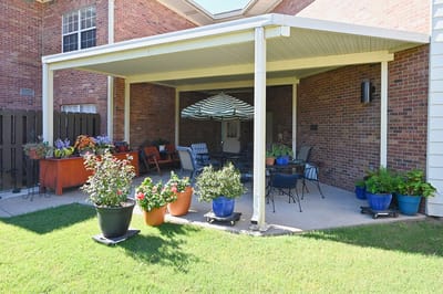 Outdoor patio area with flowers and seating