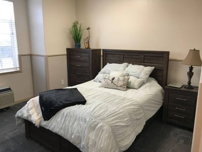 A cozy bedroom setup with a bed and dresser