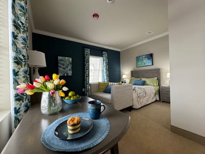 Cozy resident room setup with flowers and snack
