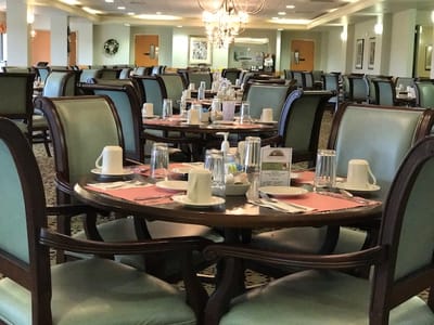 Empty dining room with set tables for meals
