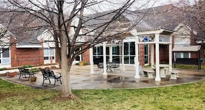 Outdoor patio area with seating and landscaping
