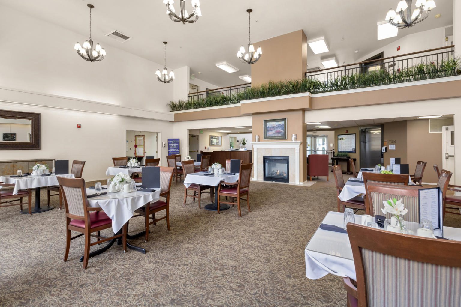 Interior dining area with tables and decorative flowers