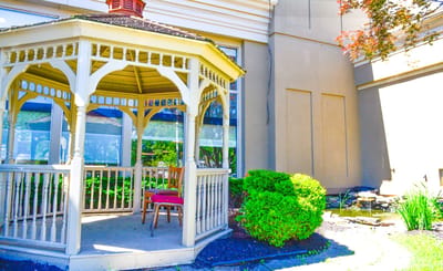 Outdoor gazebo with seating and greenery