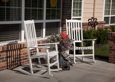 Rocking chairs on a porch with flowers