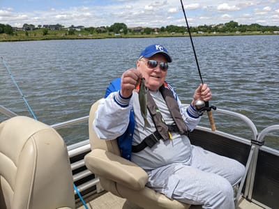 Resident fishing by a serene lake