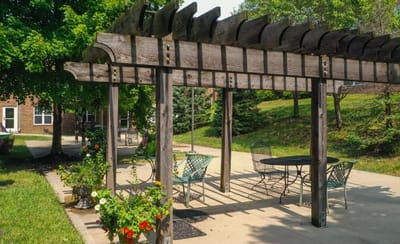 Outdoor pergola with seating and flowers