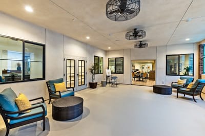 Bright common area with seating and large windows