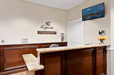 Reception area with a wooden counter and flowers