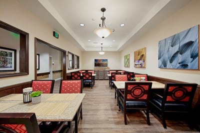 Interior view of a dining area with tables and artwork